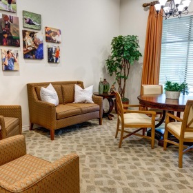 Find your perfect fit at The Auberge at Onion Creek a living room with a table and chairs