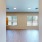 a room with a wood floor and windows