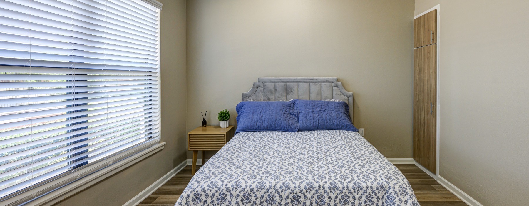 Bedroom with full bed and nightstand