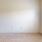 a room with a wood floor and a window