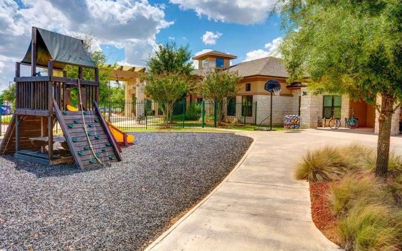 a playground with a building behind it