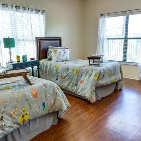 Settle into comfort at The Auberge at Onion Creek a bedroom with two beds